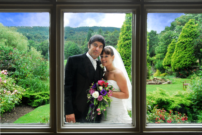 The Bride and Groom framed by a window