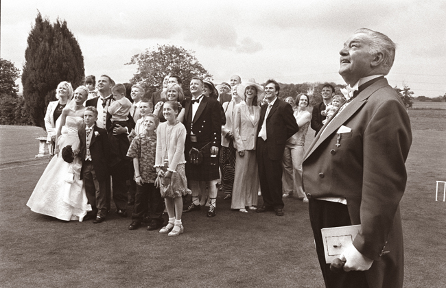 The wedding guests get ready for the group photograph